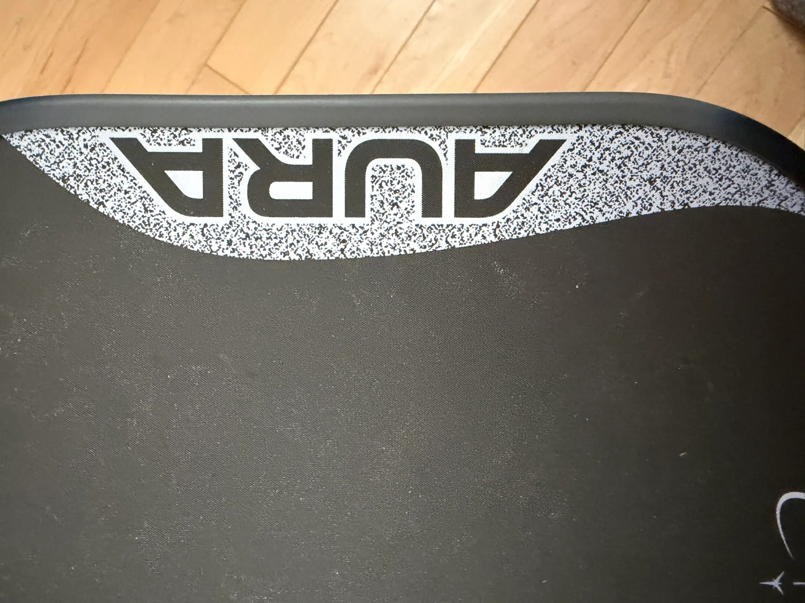 The Aura logo on the face